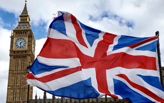A Union Jack flag flutters in the wind near Big Ben and Parliament in Parliament Square in London March 29. (OSV News/Reuters/Kevin Coombs)